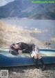 A woman in a school uniform laying on a boat.