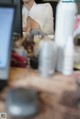 A woman sitting at a desk in front of a computer.