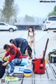 A group of people standing on top of a wooden dock.