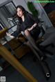 A woman sitting at a desk in an office.