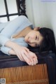 A woman laying on top of a wooden table.